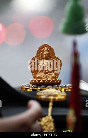 Goddess of Mercy, Avalokitesvara Bodhisattva figurine in a car. Ho Chi Minh City. Vietnam. | usage worldwide Stock Photo