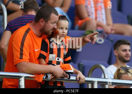 JULY 29, 2018 - KHARKIV, UKRAINE: FC Shakhtar Donetsk fans. Young child. Boy and his father supporting their team on the stands. Ukrainian Premier Lea Stock Photo