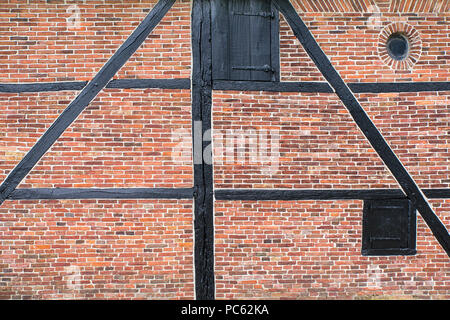 Brick wall of half-timbered house or water mill with wooden beams Stock Photo