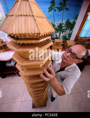 Shijiazhuang, China's Hebei Province. 31st July, 2018. Zhang Xiaocheng checks a model of ancient building made of discarded wooden sticks in Chengguan Town of Wu'an City, north China's Hebei Province, July 31, 2018. 70-year-old Zhang has made over 60 handicrafts using discarded wooden sticks. Credit: Wang Xiao/Xinhua/Alamy Live News Stock Photo