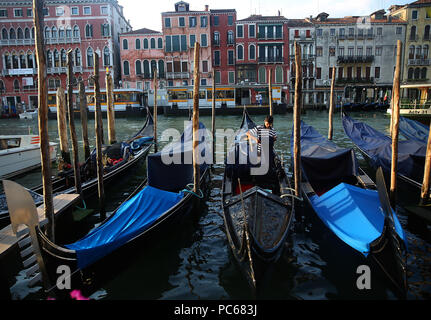 Venice, Italy. 8th July, 2018. Gondolas sits along the Grand Canal in Venice, Italy. Venice, the capital of northern Italy's Veneto region, is built on more than 100 small islands in a lagoon in the Adriatic Sea. It has no roads, just canals ''“ including the Grand Canal thoroughfare ''“ lined with Renaissance and Gothic palaces. Credit: Leigh Taylor/ZUMA Wire/Alamy Live News Stock Photo