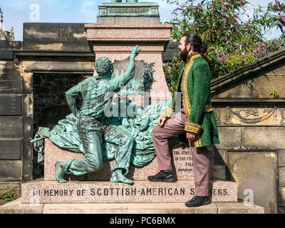 Edinburgh Fringe Festival, Henry Box Brown: Musical Journey photocall, 1st August 2018. Edinburgh, Scotland, UK. The cast at Abraham Lincoln Memorial, Old Calton Burial Ground, which commemorates the  Scots who fought on behalf of the Union in America. Ben Harney and writer Mehr Mansuri create the musical about a 1850s Virginia slave who ships himself to freedom in a box. An male actor in 19th century costume stands at the memorial Stock Photo
