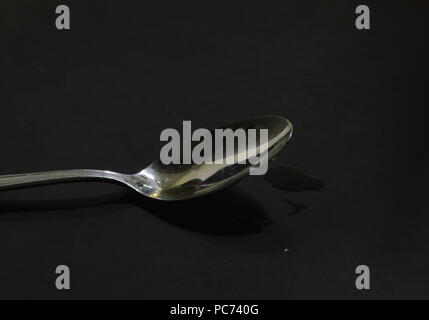 tea spoon on black counter Stock Photo