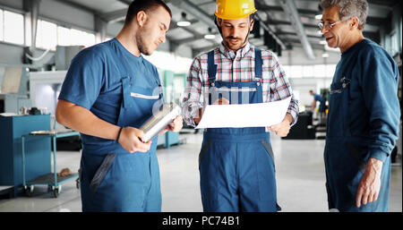 Engineer Teaching Apprentices To Use Computerized cnc metal processing machines Stock Photo