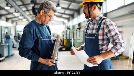 Team Of Engineers Having Discussion In Factory Stock Photo