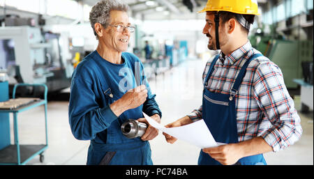 Team Of Engineers Having Discussion In Factory Stock Photo