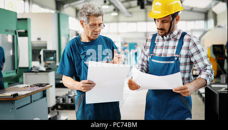 Supplier with engineer checking on production in factory Stock Photo