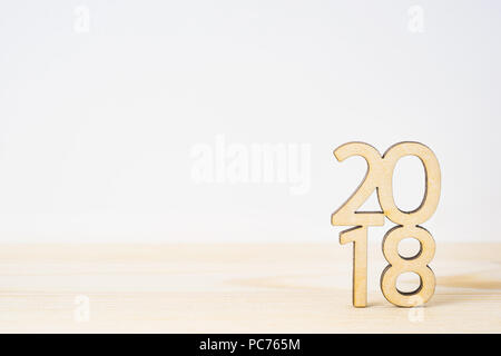 Business and design concept - wooden word ' 2018 ' on table and white background