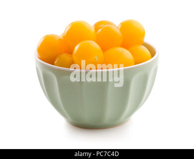 Yellow cherry tomatoes in bowl isolated on white background. Stock Photo