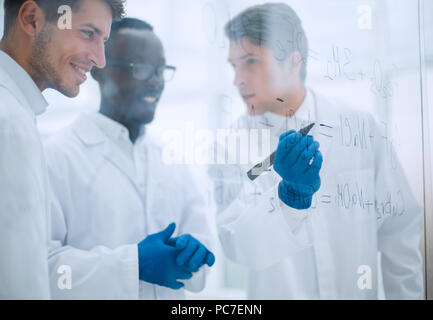 promising scientist makes notes on the Board Stock Photo