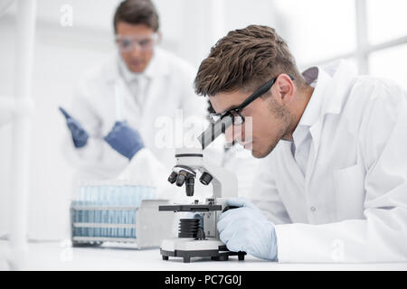 close up.the scientist looks through the microscope Stock Photo
