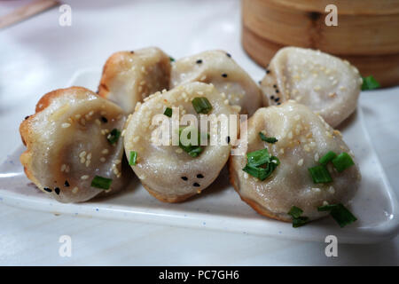 Shanghai pan fried pork dumpling on white plate Stock Photo