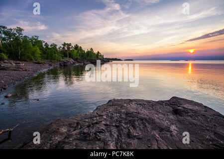 Summer Sunset At The Lake. Beautiful sunset over the horizon of Lake Superior at Copper Harbor in the Upper Peninsula of Michigan. Stock Photo