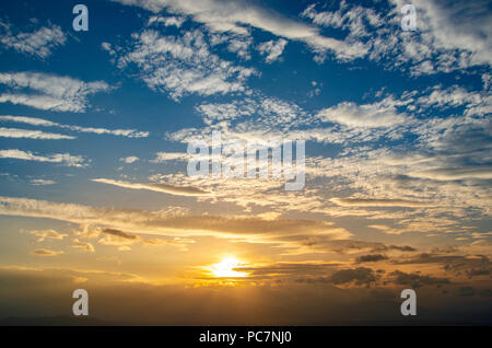 Cirrocumulus Morning sky Small and large clouds are dense with the sun below Stock Photo