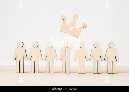 Business and design concept - group of wooden businessman icon with leadership concept on wooden desktop and white background Stock Photo