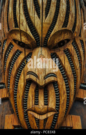 Traditional wood carved mask in the Te Puia Maori Cultural Center, Roturura, North Island, New Zealand Stock Photo