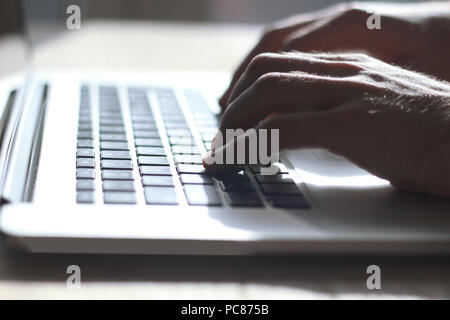 close up. male typing text on laptop keyboard Stock Photo