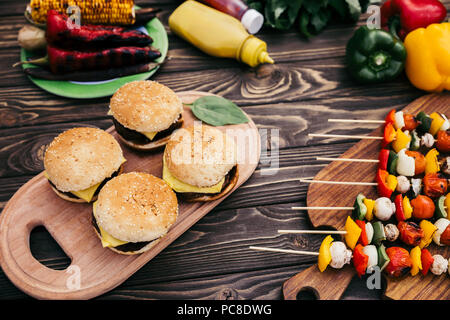 Seasonal vegetables and burgers grilled for outdoors barbecue Stock Photo