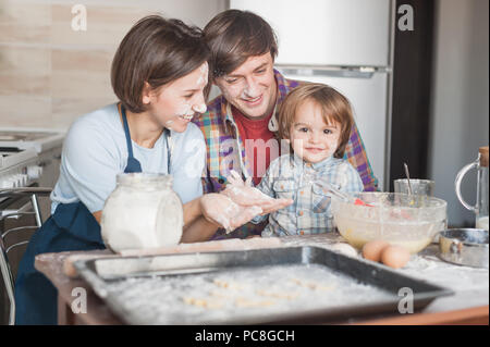 happy young family cooking with floor together at kitchen Stock Photo