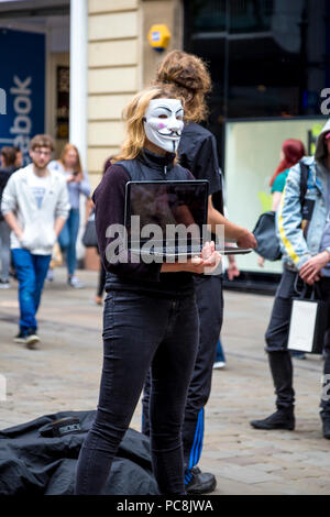 2nd June 2018 Manchester, UK - Anonymous wearing masks protesting animal cruelty in the food industry Stock Photo
