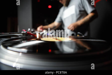 Professional dj turntable records player in close up. Disc jockey mixing music on background. Sound recording studio equipment Stock Photo