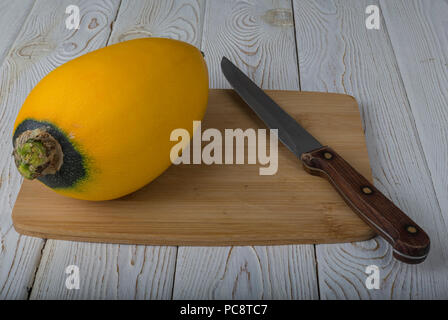 Vegetables (zucchini and patisson) on the board.