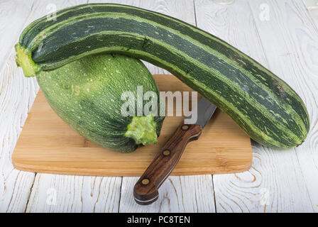 Vegetables (zucchini and patisson) on the board.