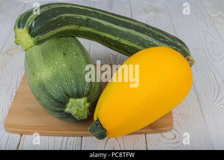 Vegetables (zucchini and patisson) on the board.