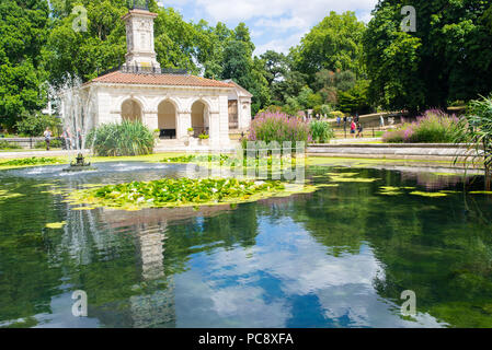 Kensington Gardens, The Italian Gardens with people enjoying the warm summer weather. An ornamental water garden on the north side of Hyde park, near  Stock Photo
