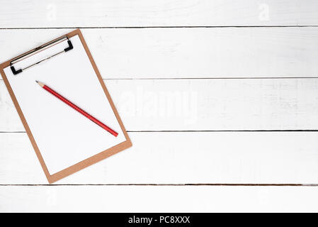 White notepad on red lapis over white wooden background Stock Photo