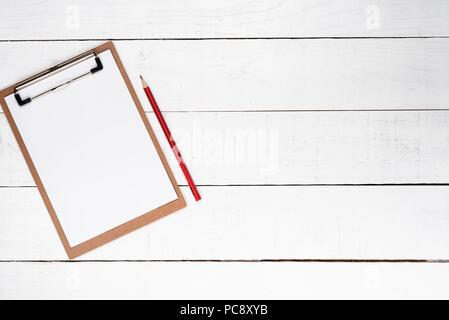 White notepad on red lapis over white wooden background Stock Photo