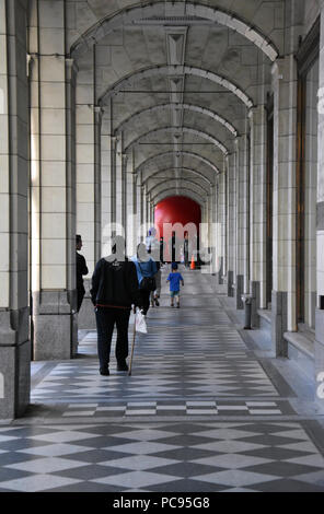 The Red Ball Project by artist Kurt Perschke in the walkway of the downtown Hudson's Bay store in Calgary, Alberta, Canada Stock Photo