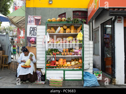 Fruits street vendor preparing the pineapple for sale. La Paz, Bolivia. Jun 2018 Stock Photo