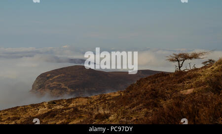 Hill tops sticking out of the clouds on a sunny day in Sutherland, Scotland Stock Photo