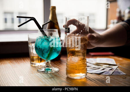 Drinks in a pub with a pack of cards Stock Photo