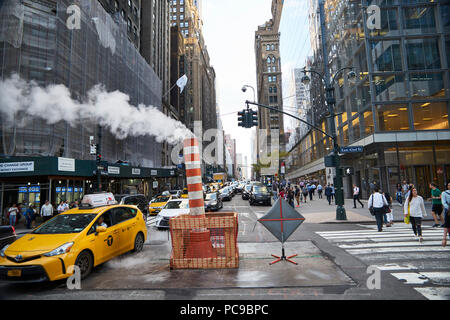 steam leak coming out a temporary chimney at a busy midtown 42nd street in Manhattan Stock Photo