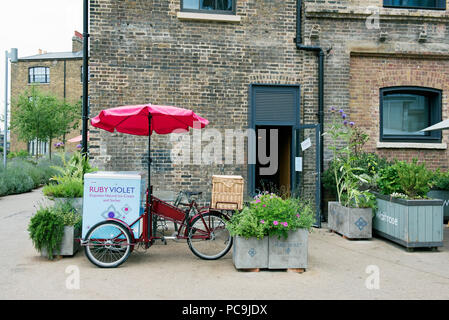 Ruby Violet Ice Cream bicycle with red sunshade in front of shop Kings Cross London England Britain UK Stock Photo