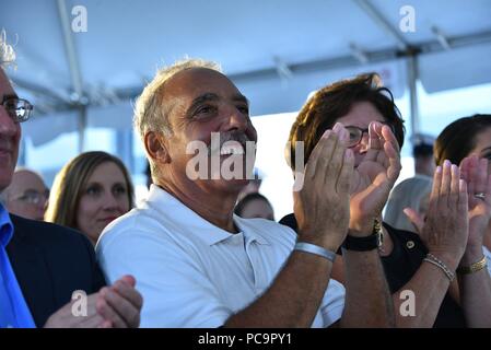 Rick Bruckenthal applauses following his daughter Noabeth Bruckenthal's speech during the commissioning ceremony for the Coast Guard Cutter Nathan Bruckenthal in Old Town Alexandria, Virginia, July 25, 2018, July 25, 2018. Bruckenthal is the Coast Guard's 28th Fast Response Cutter named after Coast Guard Petty Officer 3rd Class Nathan Bruckenthal, who was fatally wounded during Operation Iraqi Freedom in the Arabian Gulf in 2004. U.S. Coast Guard photo by Petty Officer 1st Class Jetta Disco. Image courtesy Petty Officer 1st Class Jetta Disco/U.S. Coast Guard Headquarters. () Stock Photo