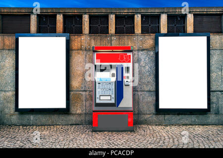 Two blank billboards attached on a wal besides a ticket machinel copy Stock Photo