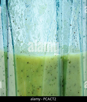 Kiwi and banana smoothie. Smoothie in blender closeup. Stock Photo