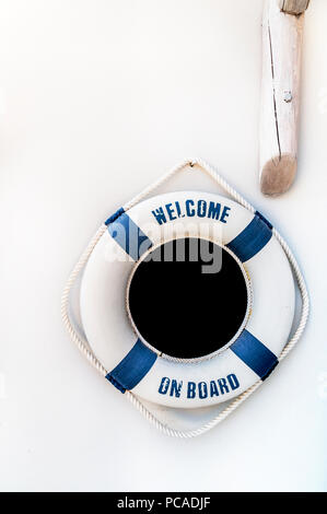 White and blue lifebuoy on white wall, float on the wall Stock Photo