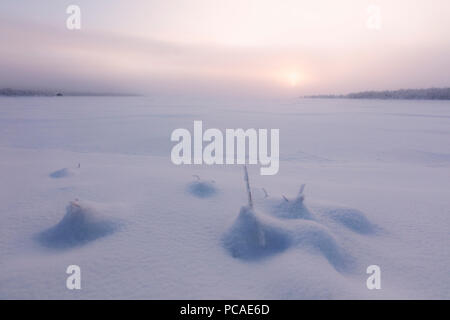Misty sunrise on the snowy landscape, Muonio, Lapland, Finland, Europe Stock Photo