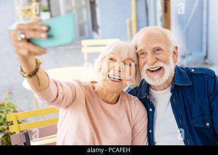 Positive senior couple taking selfie Stock Photo