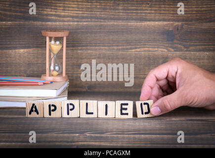 applied. wooden letters on the office desk Stock Photo