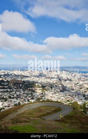 Beautiful aerial view of the San Francisco Twin Peaks overlooking the city's scenic skyline with numerous buildings and landmarks in the background Stock Photo
