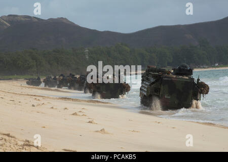 180728-M-KC456-1059 MARINE CORPS TRAINING AREA BELLOWS, Hawaii (July 28, 2018) U.S. Marine Corps AAV-P7/A1 assault amphibious vehicles move into position after landing on the beach during an amphibious assault as part of Rim of the Pacific (RIMPAC) exercise on Marine Corps Training Area Bellows, Hawaii, July 28, 2018. RIMPAC provides high-value training for task organized, highly capable Marine Air-Ground Task Force and enhances the critical crisis response capability of U.S. Marines in the Pacific. Twenty-Five nations, 46 ships, five submarines, about 200 aircraft, and 25,000 personnel are pa Stock Photo