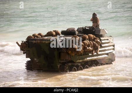 180729-M-ZO893-1012 MARINE CORPS HAWAII (July 29, 2018) U.S. Marines with Combat Assault Company, 3rd Marine Regiment, come ashore in AAV-P7/A1 assault amphibious vehicles on Pyramid Rock Beach during an amphibious landing demonstration as part of Rim of the Pacific (RIMPAC) exercise on Marine Corps Base Hawaii July 29, 2018. RIMPAC provides high-value training for task-organized, highly capable Marine Air-Ground Task Force and enhances the critical crisis response capability of U.S. Marines in the Pacific. Twenty-five nations, 46 ships, five submarines, about 200 aircraft and 25,000 personnel Stock Photo