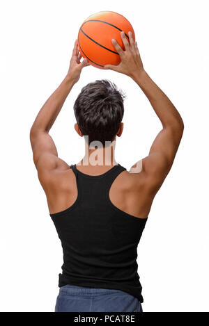 Portrait of a young basketball player passing the ball. Young caucasian boy in sportswear playing basketball on white background with copyspace Stock Photo