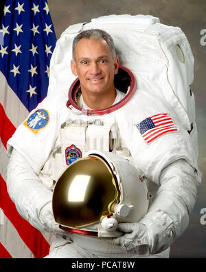 Official Portrait of Astronaut John D. (Danny) Olivas in his white Extravehicular Mobility Unit (EMU) Stock Photo
