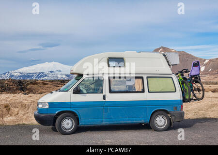 16 April 2018: Budir, Snaefellsnes Peninsula, West Iceland - Volkswagen T4 Campervan with bikes on the back, and the Snæfellsjokull Volcano in the... Stock Photo